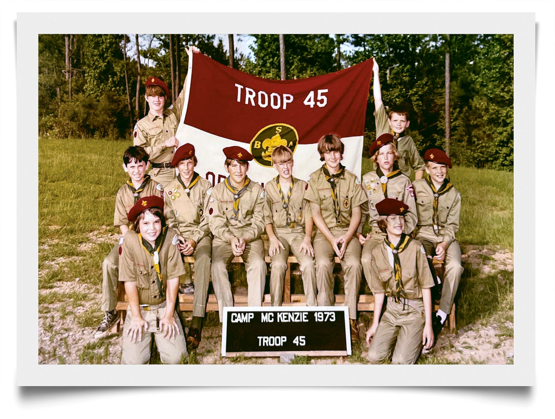 Boy Scouts posing around Troup 45 banner
