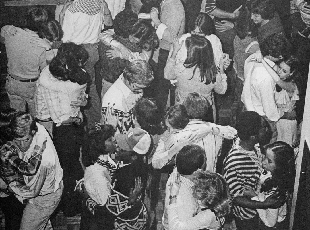 black and white photo of a large group of couples dancing closely together